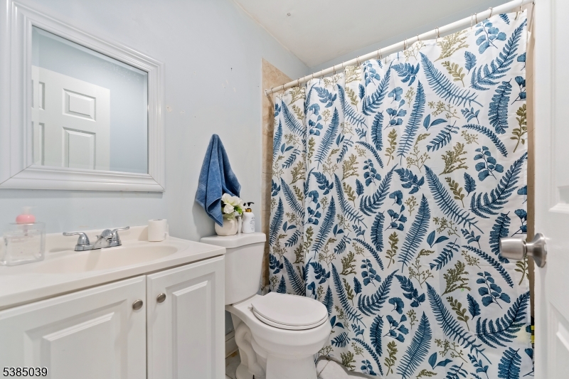 22 Godwin Avenue Paterson, NJ 07501 - Photo 10 of 16 a bathroom with a sink toilet and a mirror