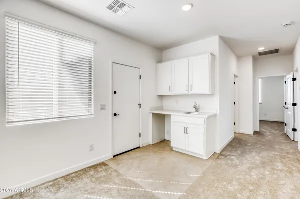 a view of white cabinets and window