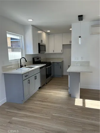 a kitchen with a sink stove and cabinets