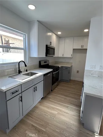 a bathroom with a granite countertop sink and mirror