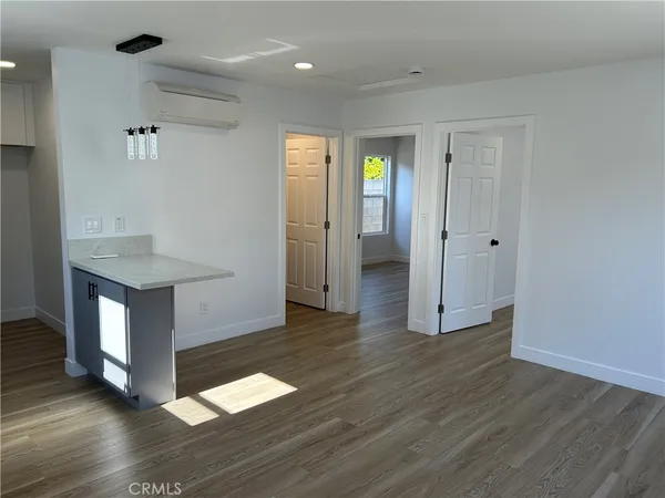 a kitchen with a sink cabinets and wooden floor