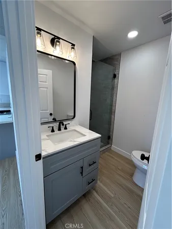 a bathroom with a sink a mirror and a shower