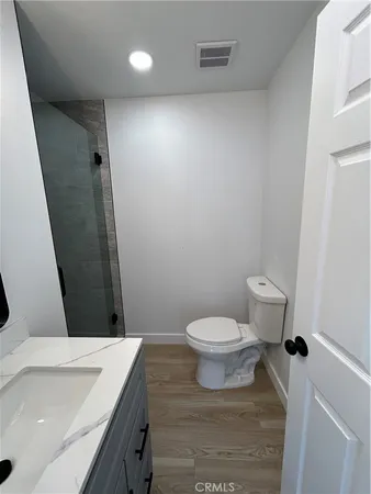 a bathroom with a shower and a toilet with a shower