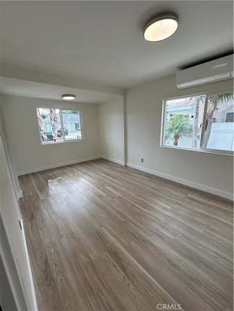 a view of a room with wooden floor and fan
