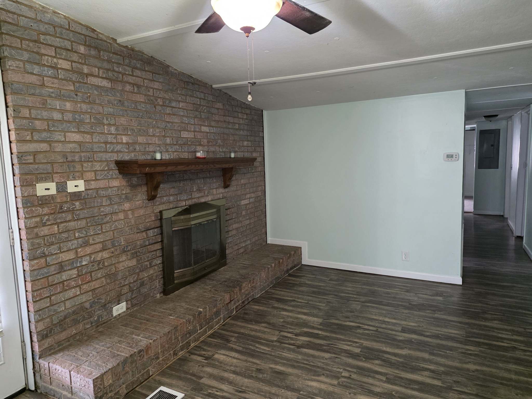 65 Anthony Mill Road Tullahoma, TN 37388 - Photo 13 of 43 a view of an empty room with wooden floor and a fireplace