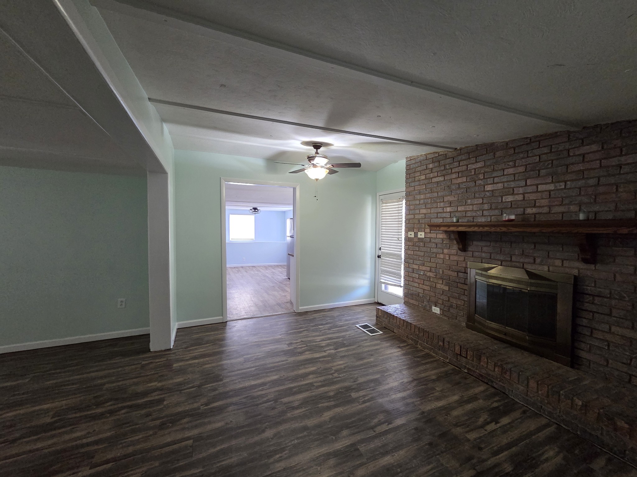 65 Anthony Mill Road Tullahoma, TN 37388 - Photo 14 of 43 an empty room with wooden floor fireplace and staircase