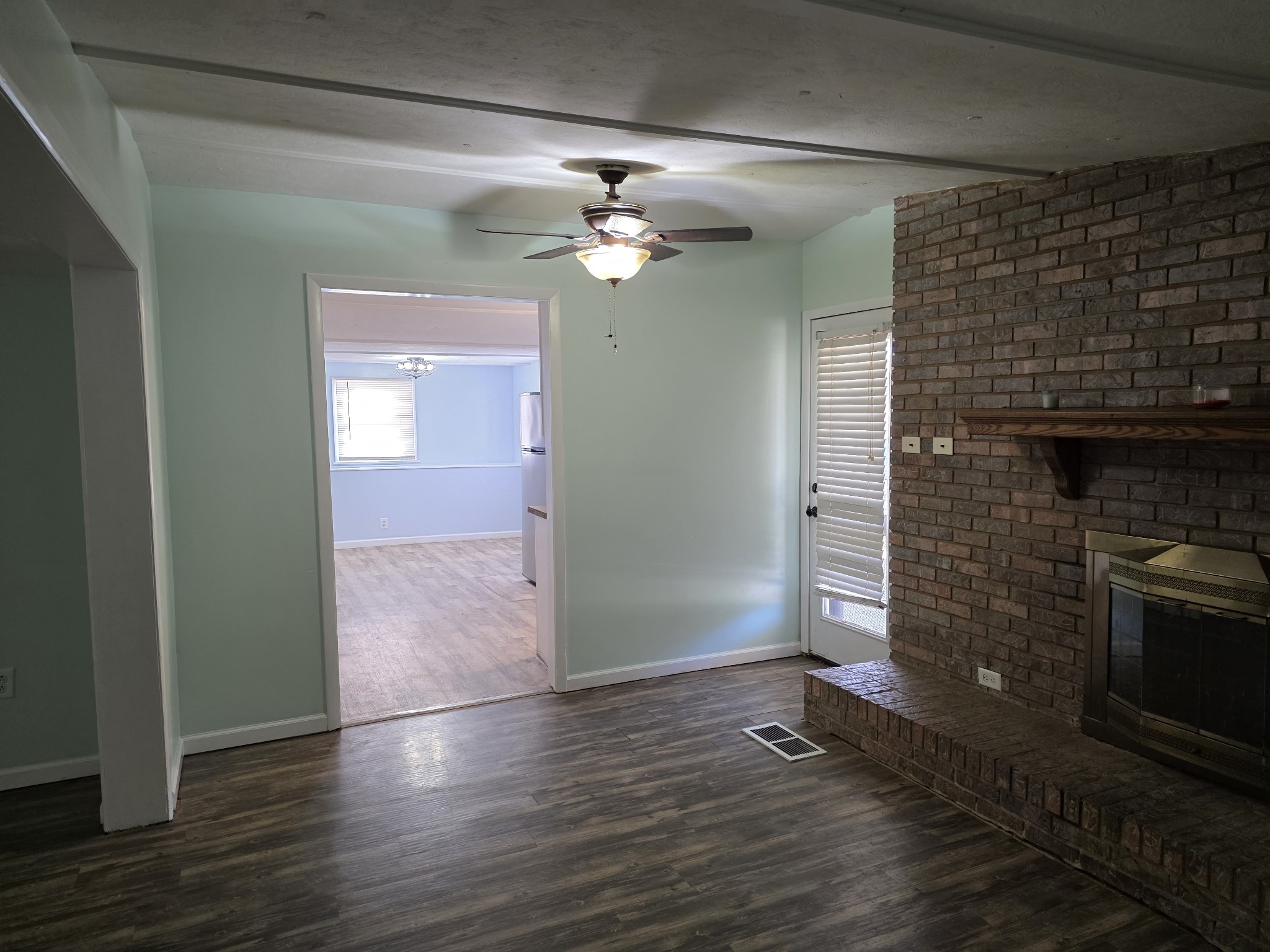 65 Anthony Mill Road Tullahoma, TN 37388 - Photo 15 of 43 an empty room with wooden floor a ceiling fan and staircase