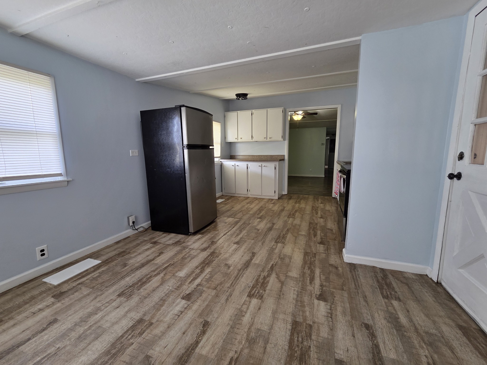 65 Anthony Mill Road Tullahoma, TN 37388 - Photo 22 of 43 a view of a kitchen with wooden floor and a refrigerator