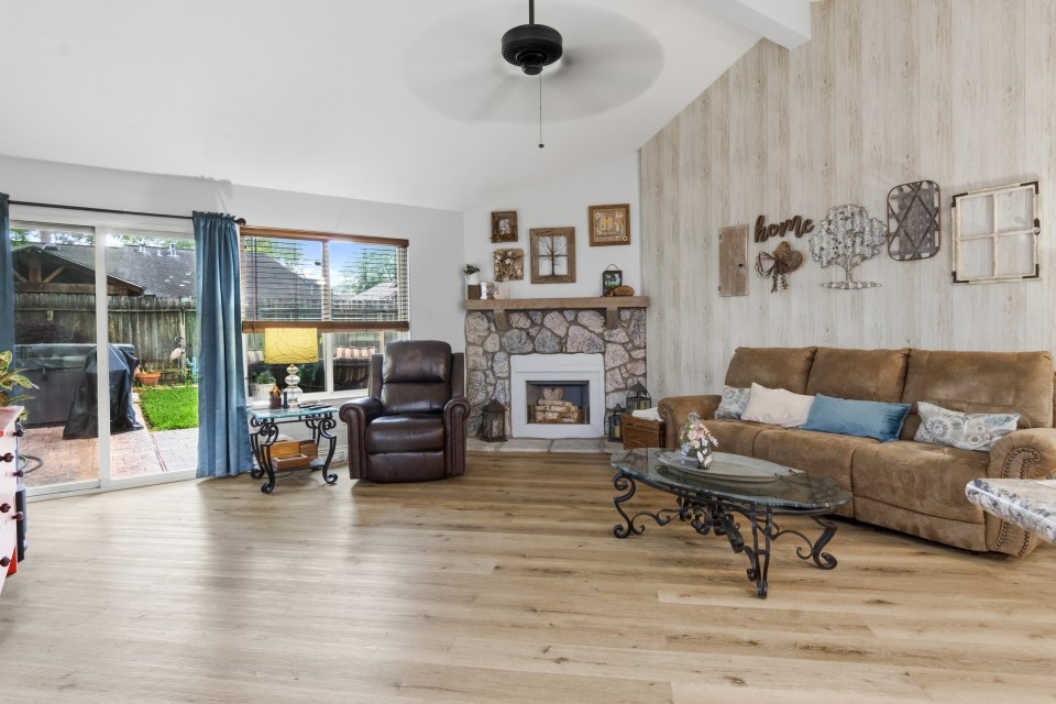 9211 Benwick Street Spring, TX 77379 - Photo 6 of 27 a living room with furniture and a fireplace