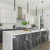 a kitchen with stainless steel appliances kitchen island a table and chairs in it