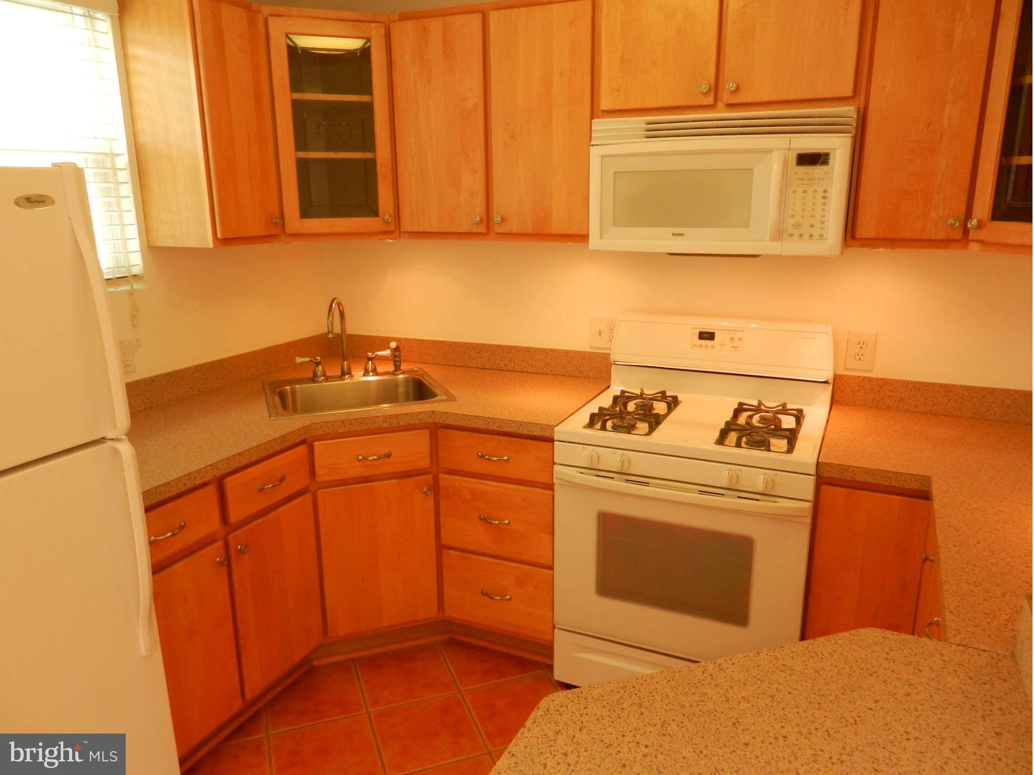 3110 Cornwall Road Baltimore, MD 21222 - Photo 15 of 28 a kitchen with stainless steel appliances granite countertop a sink stove and refrigerator