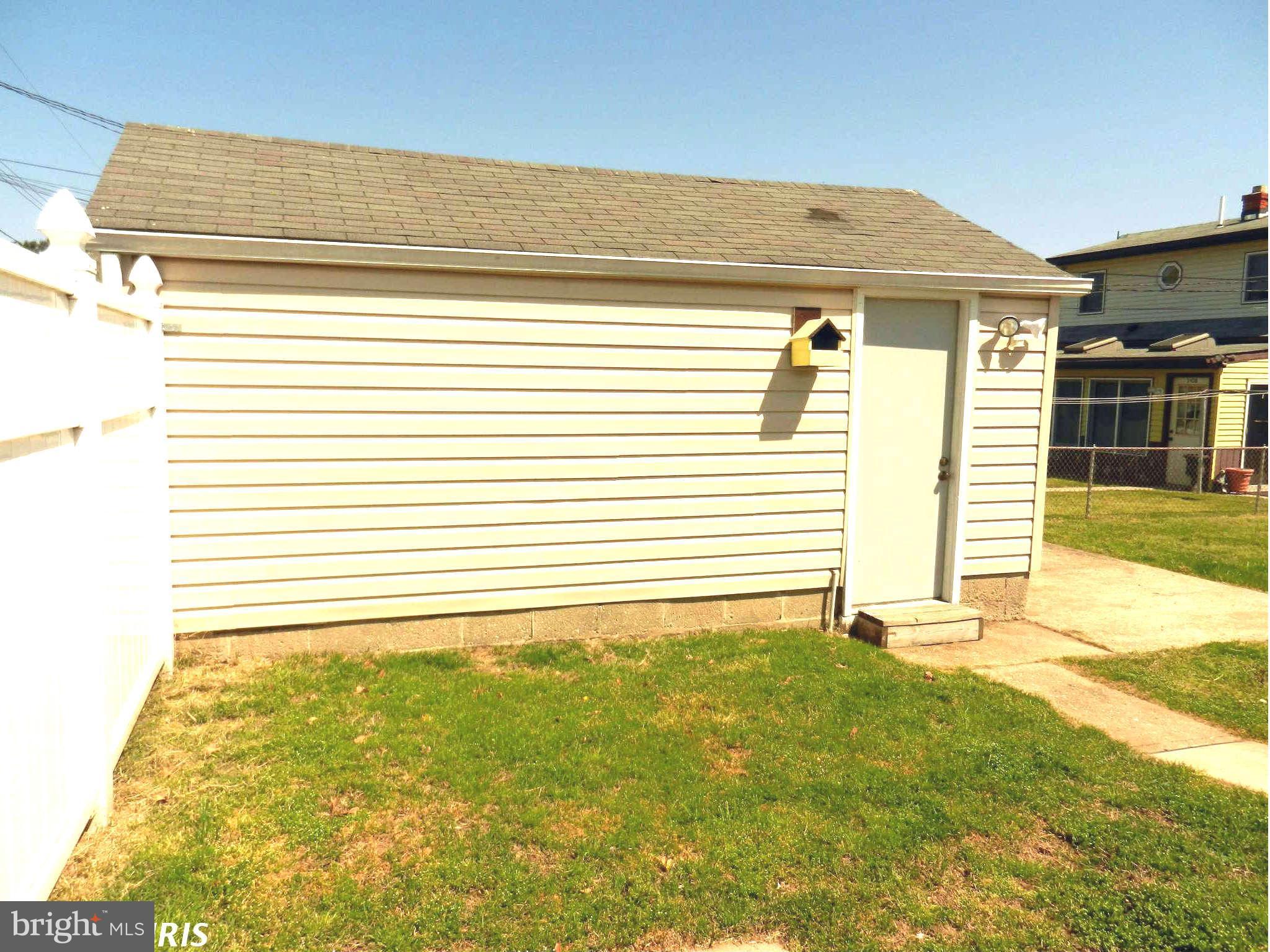3110 Cornwall Road Baltimore, MD 21222 - Photo 27 of 28 a view of a house with a yard and a garage