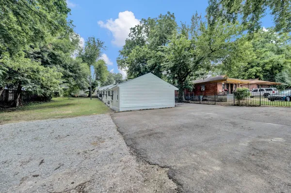 a view of house with outdoor space and parking
