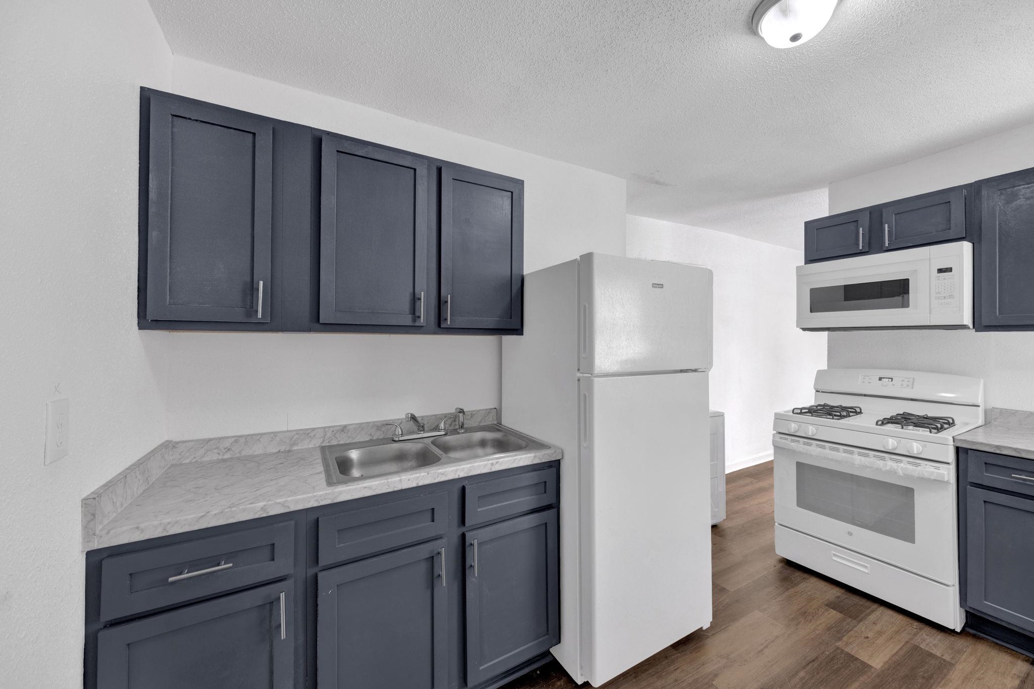 2966 Yale Avenue, Unit 3 Memphis, TN 38112 - Photo 3 of 24 Kitchen with white appliances, dark wood-style flooring, a textured ceiling, and gray cabinets
