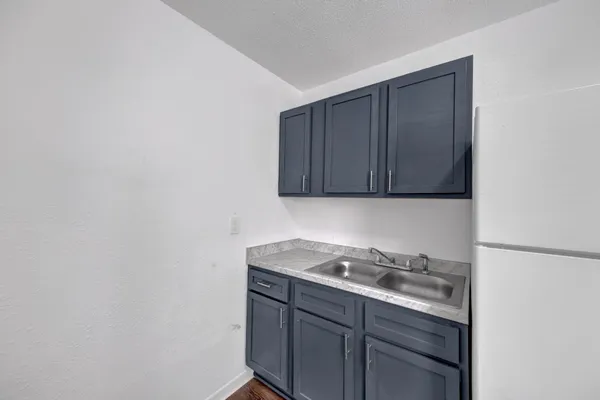 a room with a sink cabinets and utility