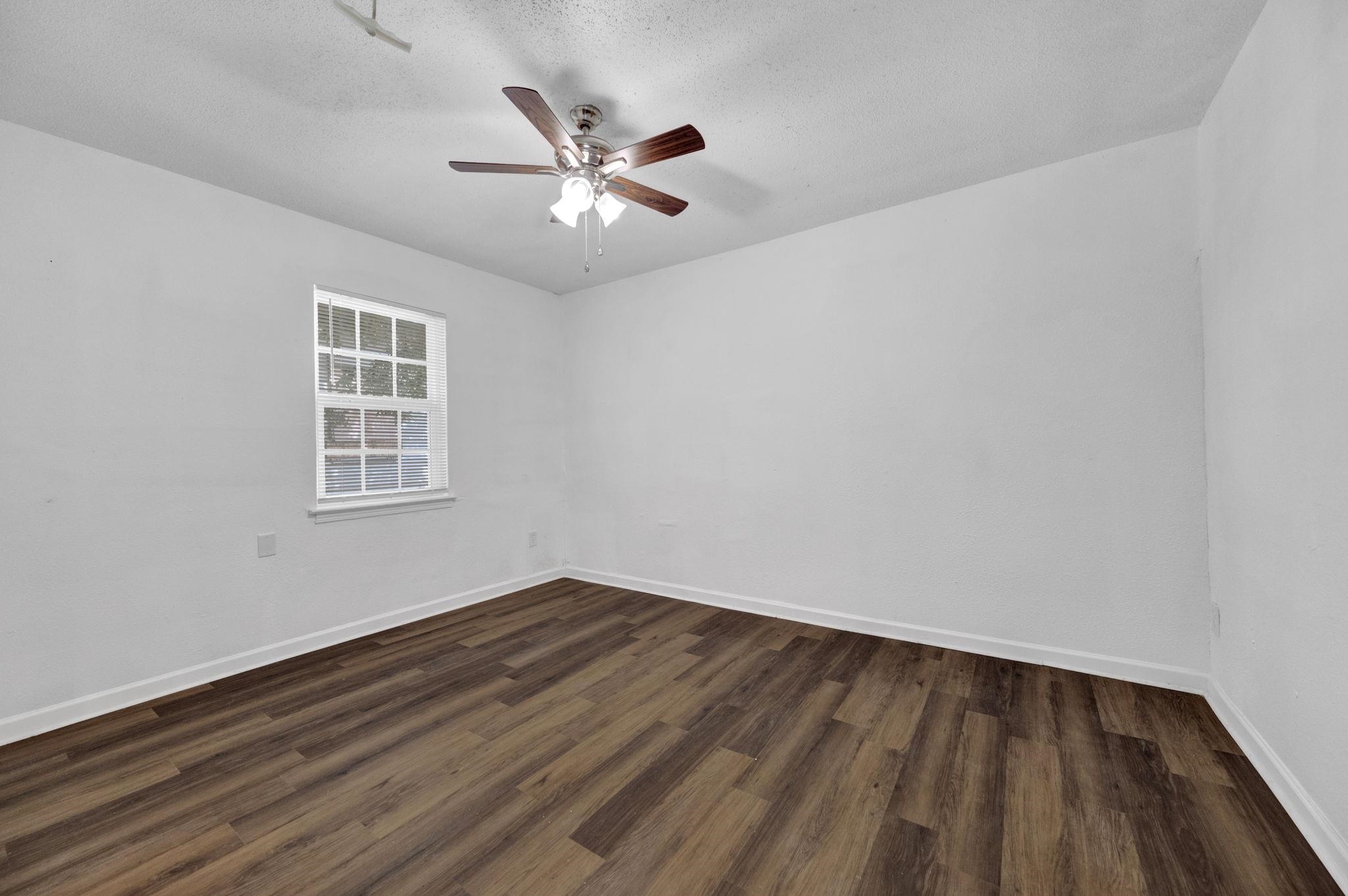 2966 Yale Avenue, Unit 3 Memphis, TN 38112 - Photo 8 of 24 Empty room with dark wood-style floors, a textured ceiling, and ceiling fan