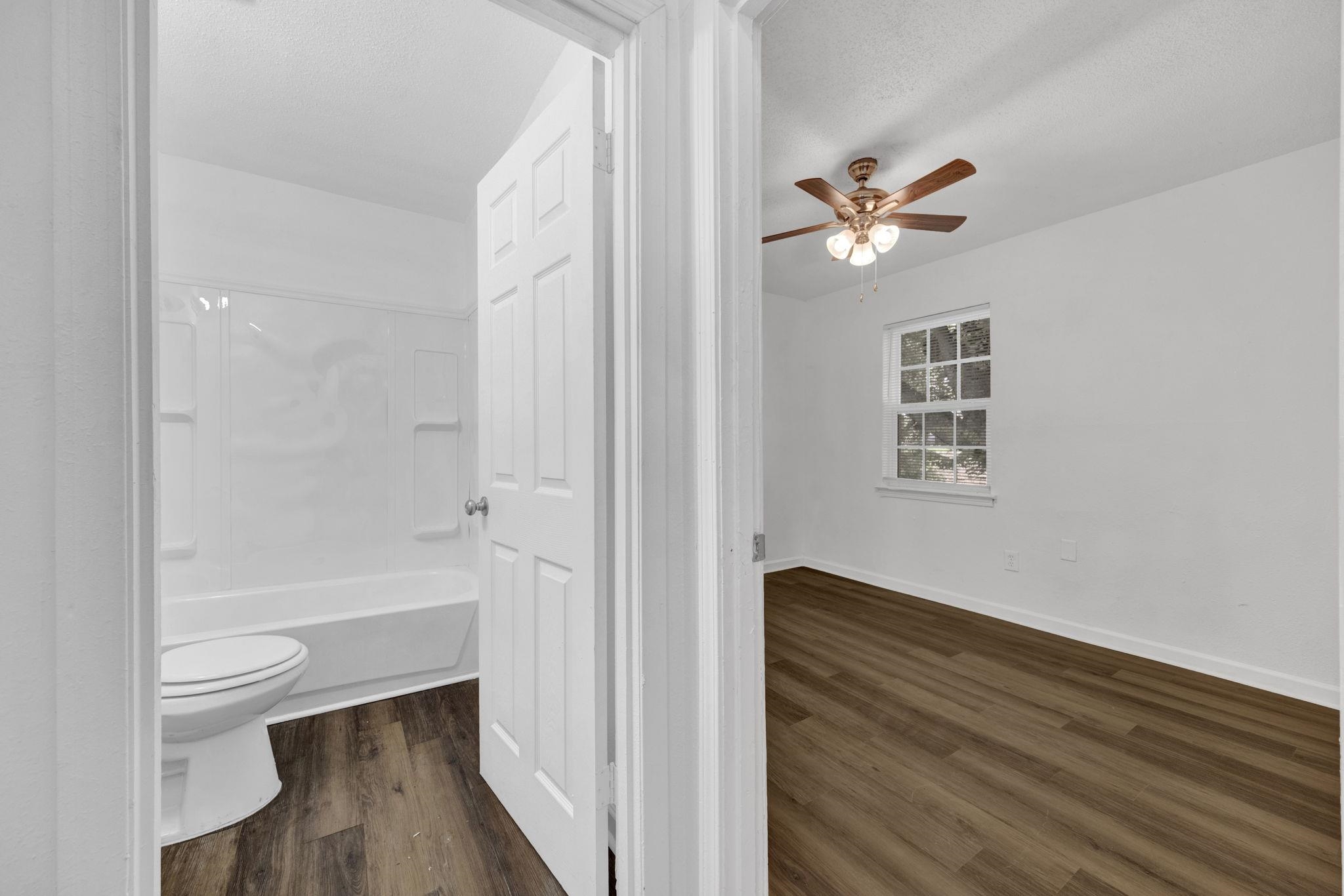 2966 Yale Avenue, Unit 3 Memphis, TN 38112 - Photo 10 of 24 Bathroom featuring dark wood finished floors, a textured ceiling, shower / washtub combination, and ceiling fan