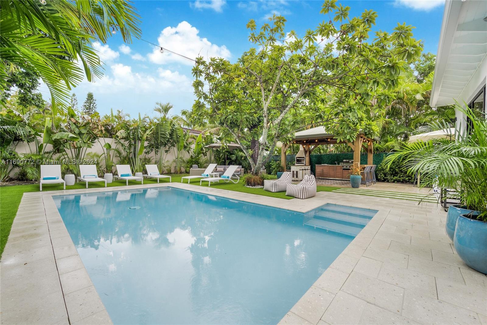 320 Southwest 24th Road Miami, FL 33129 - Photo 1 of 27 a view of a swimming pool with a patio