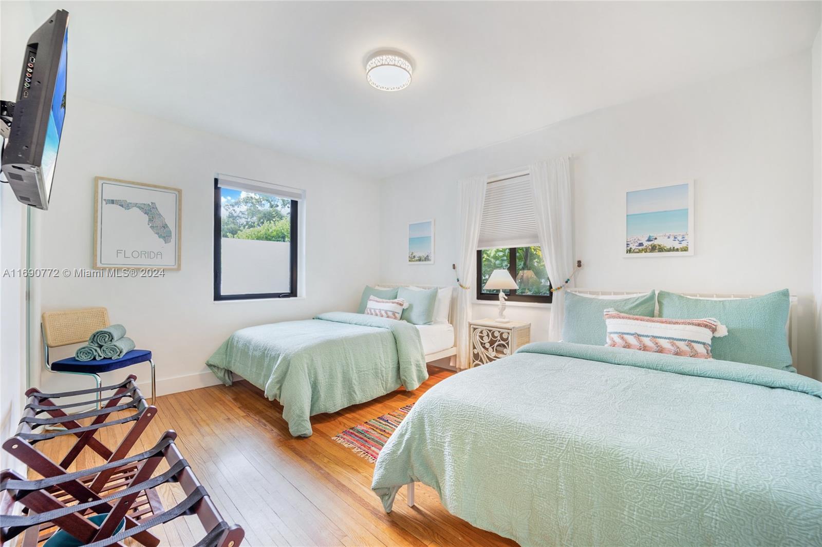 320 Southwest 24th Road Miami, FL 33129 - Photo 21 of 27 a spacious bedroom with two beds and painting on the wall