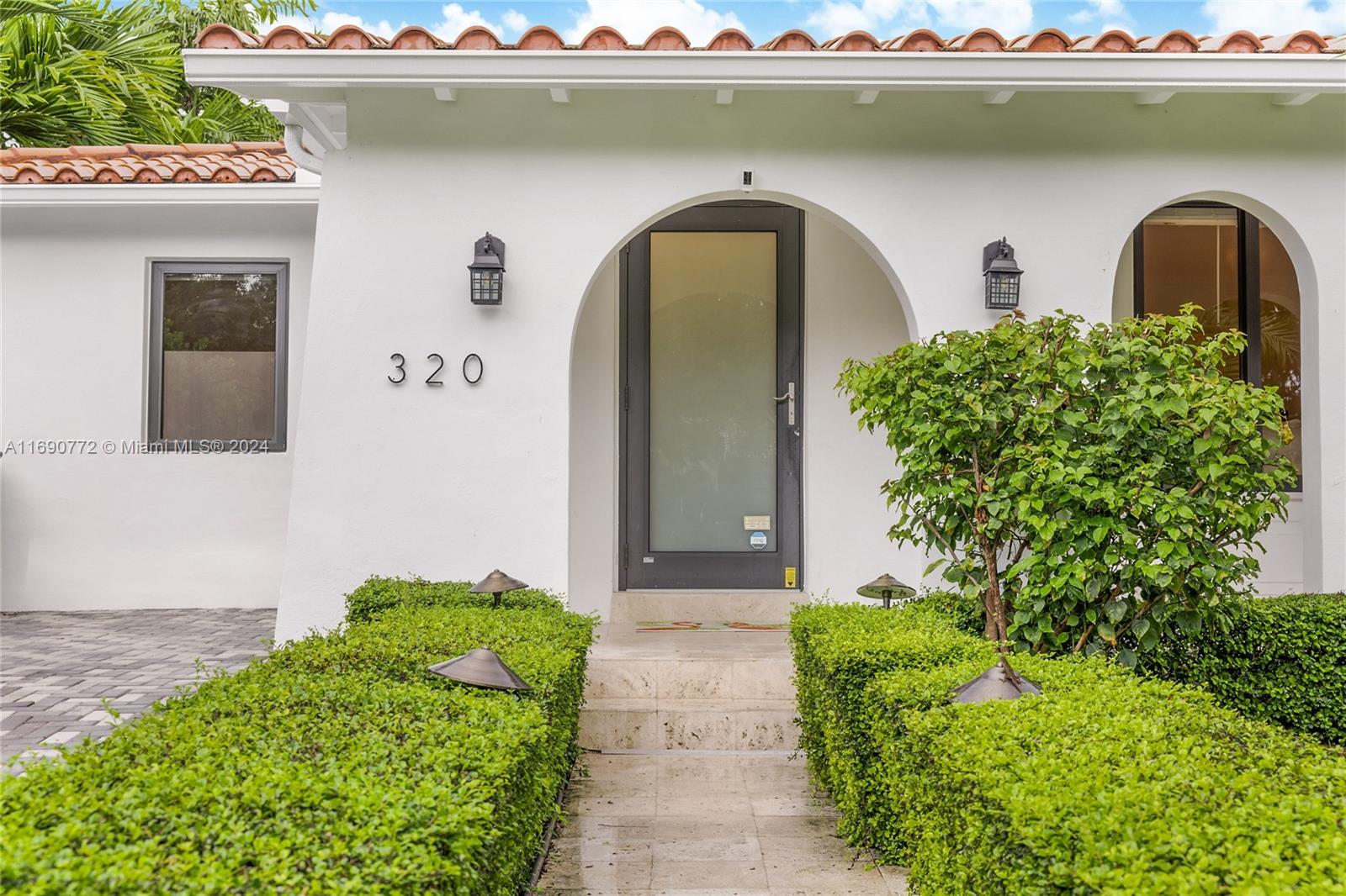 320 Southwest 24th Road Miami, FL 33129 - Photo 24 of 27 a front view of a house with a garden