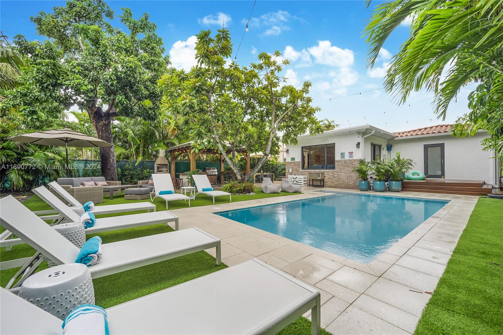 320 Southwest 24th Road Miami, FL 33129 - Photo 27 of 27 a view of a house with swimming pool and sitting area