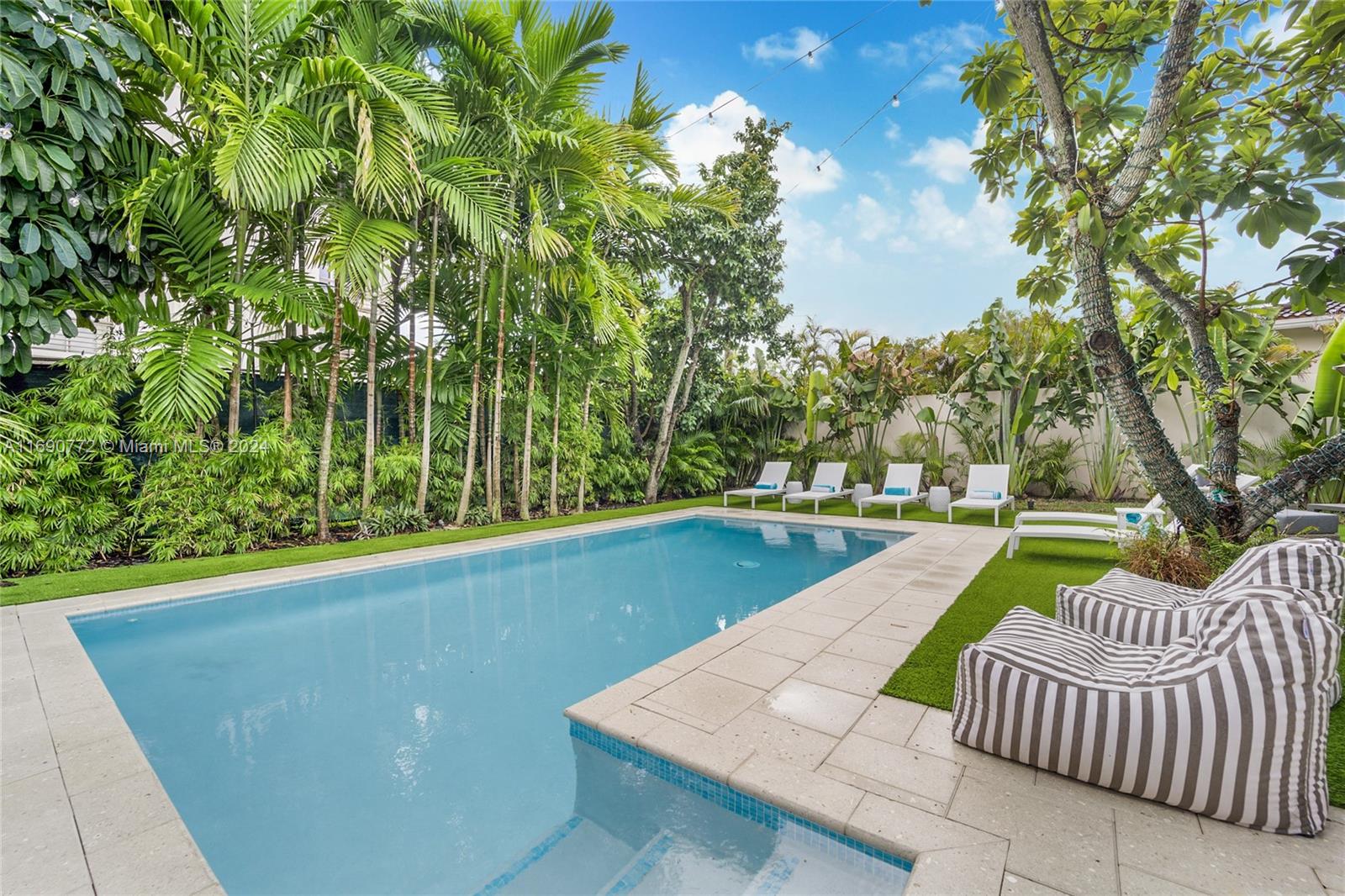 320 Southwest 24th Road Miami, FL 33129 - Photo 3 of 27 a view of swimming pool with couches and wooden fence