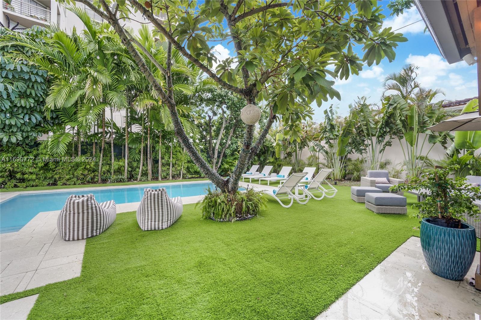 320 Southwest 24th Road Miami, FL 33129 - Photo 7 of 27 a view of a garden with potted plants and large trees