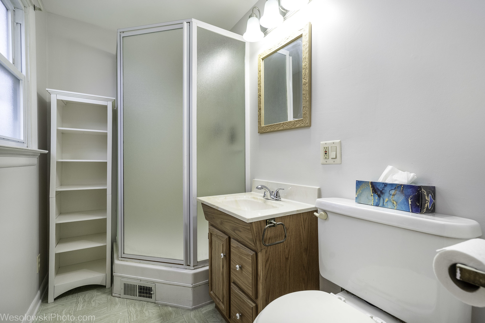 5944 West Foster Avenue Chicago, IL 60630 - Photo 13 of 21 a bathroom with a toilet sink vanity and mirror
