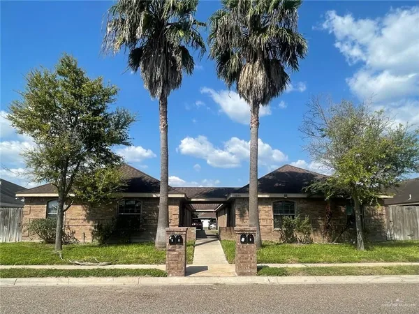 a front view of a house with yard and garage