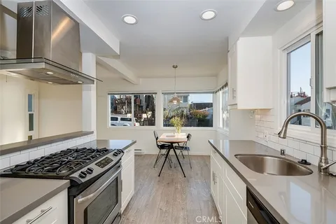 a kitchen with a stove a sink and a refrigerator