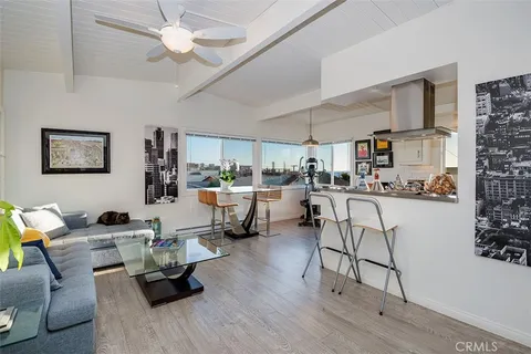 a living room with furniture and kitchen view
