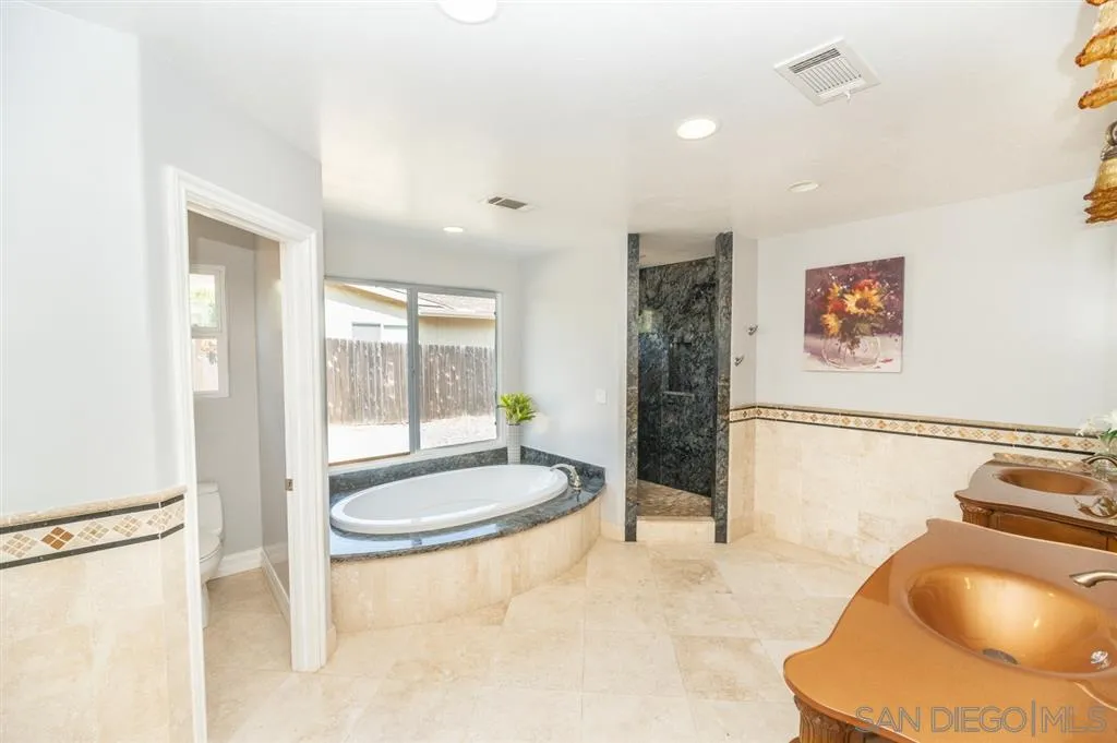 12841 Stone Canyon Road Poway, CA 92064 - Photo 13 of 25 a bathroom with a sink a tub and shower
