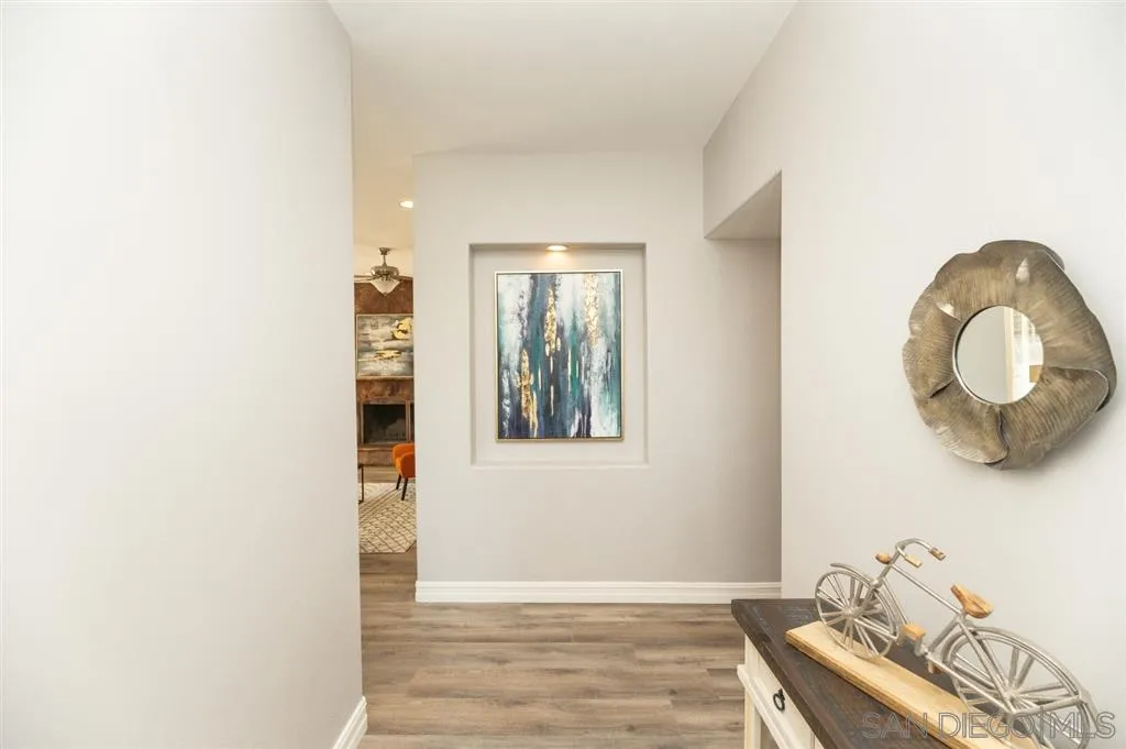 12841 Stone Canyon Road Poway, CA 92064 - Photo 3 of 25 a view of a livingroom with wooden floor and a window