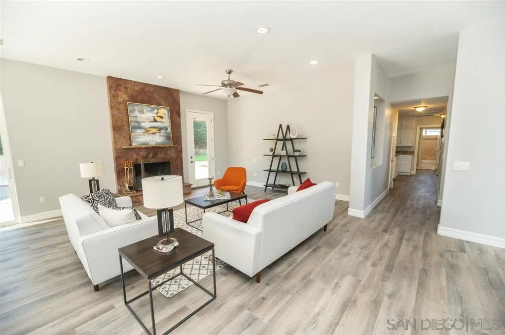 12841 Stone Canyon Road Poway, CA 92064 - Photo 4 of 25 a living room with furniture and a wooden floor