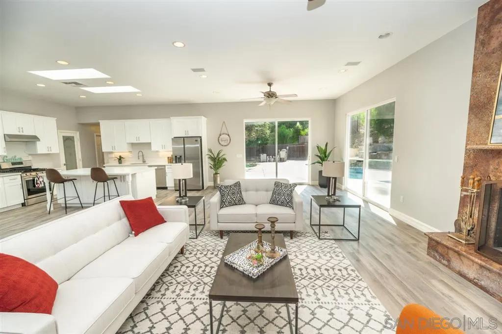 12841 Stone Canyon Road Poway, CA 92064 - Photo 5 of 25 a living room with furniture fireplace and a table