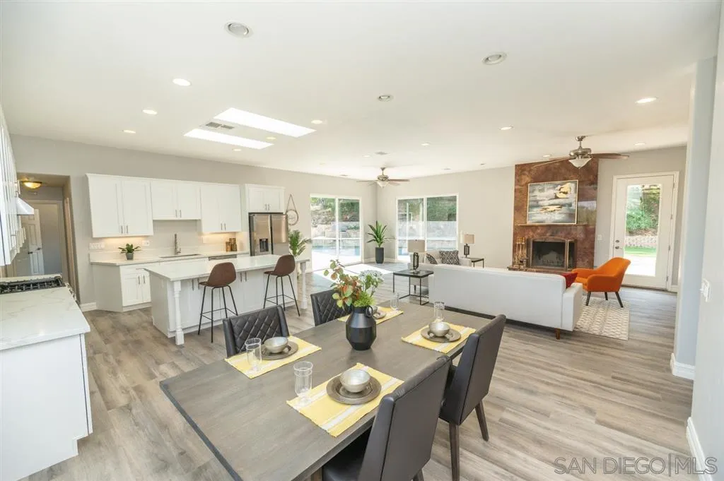12841 Stone Canyon Road Poway, CA 92064 - Photo 6 of 25 a living room with lots of furniture kitchen view and a wooden floor