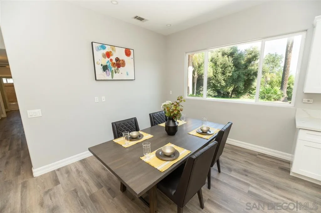12841 Stone Canyon Road Poway, CA 92064 - Photo 10 of 25 a view of a dining room with furniture window and wooden floor