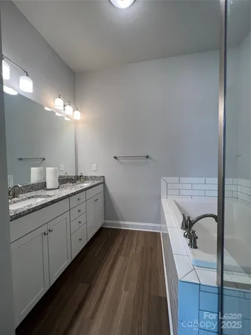 a bathroom with a double vanity sink and mirror