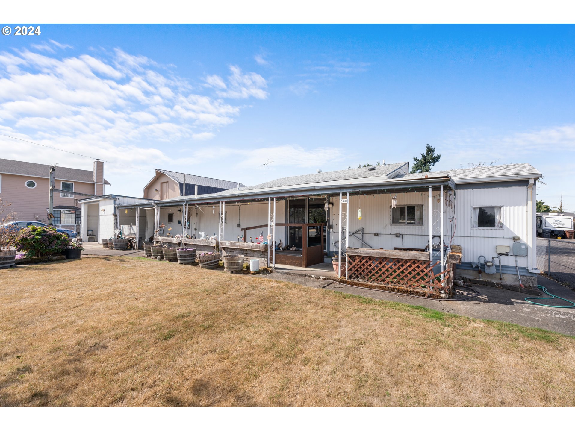 300 Ridings Avenue Molalla, OR 97038 - Photo 24 of 36 a view of a house with backyard porch and sitting area