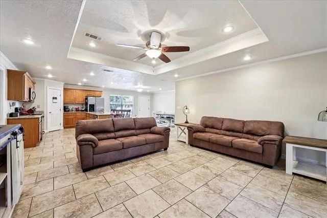 a living room with furniture and a chandelier
