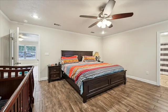 a bedroom with a bed and wooden floor