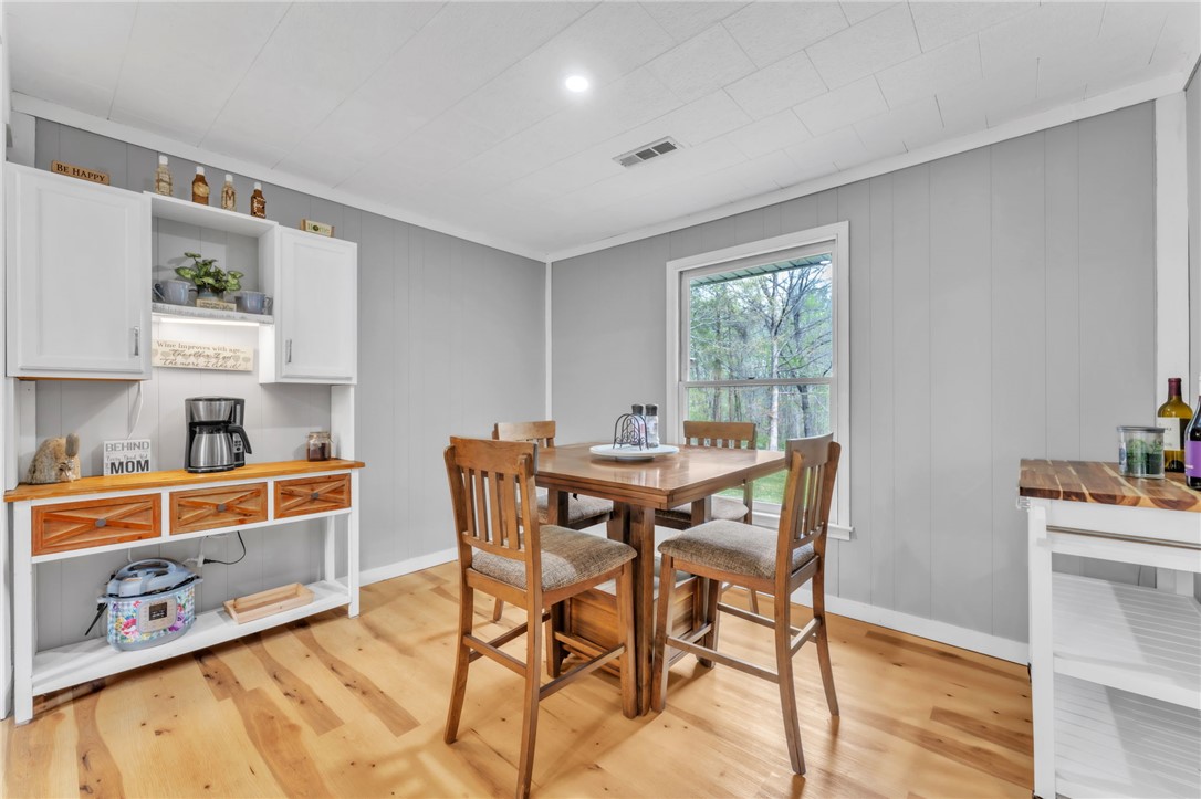 466 Whetstone Road Mountain Rest, SC 29664 - Photo 11 of 31 This dining area features gleaming hardwood flooring and a bright window overlooking the natural surroundings.