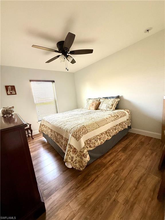 1180 Calico Street LaBelle, FL 33935 - Photo 12 of 19 a bedroom with a bed and wooden floor