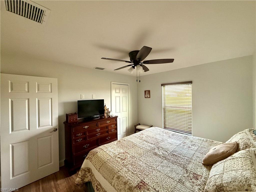 1180 Calico Street LaBelle, FL 33935 - Photo 13 of 19 a bedroom with a bed and a flat screen tv