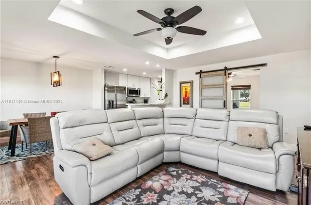 a living room with furniture ceiling fan and a rug