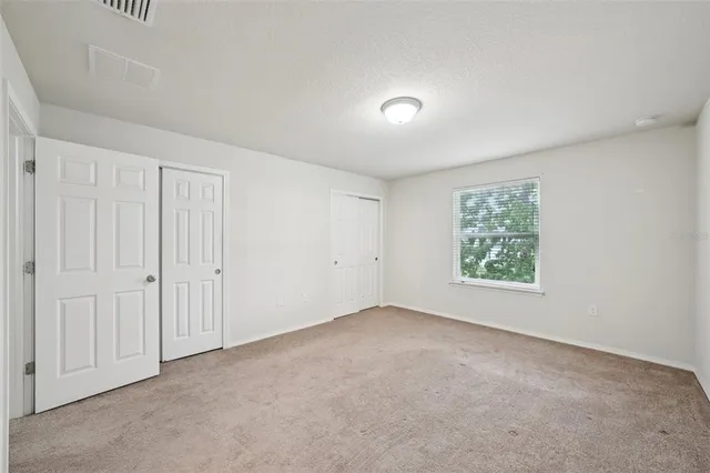 a bathroom with a granite countertop sink a toilet a mirror and shower