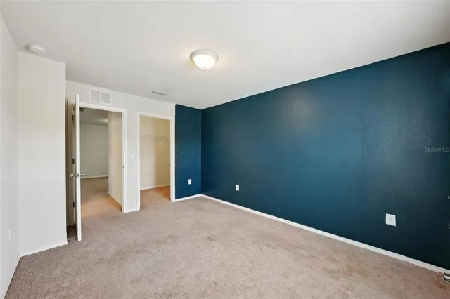 a bathroom with a granite countertop sink mirror and toilet