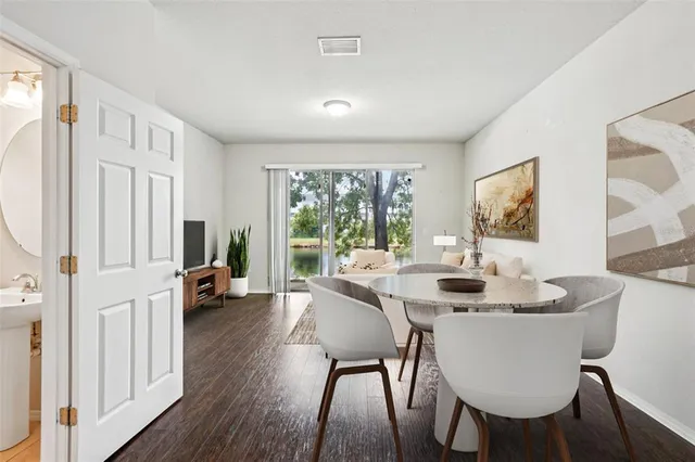 a dining room with furniture and wooden floor