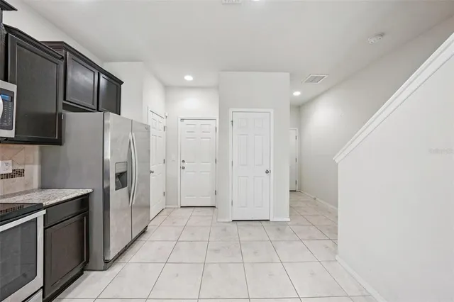 a view of a kitchen with a sink and a refrigerator