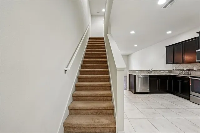 a kitchen with granite countertop a stove and a sink